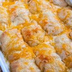 a casserole dish filled with cheese and chicken