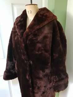 Full-length vintage MARTINS OF LONDON 'Glamar' sheepskin coat in a rich chocolate brown. Wide lapel and V-neck collar; one hook and eye to front. External pockets at both sides, lined in soft cotton. Turned-up cuffs. Fully lined in a dark wine-red fabric; lining is also in excellent condition.  This coat also includes a feature often seen in well-made fur coats: a interior 'belt' formed of two ribbons that tie anywhere between the underbust and waist, to "cinch in" the coat for a closer, more sh Formal Brown Fur Coat For Fall, Classic Long Brown Fur Coat, Classic Brown Long Fur Coat, Vintage Brown Sheepskin Outerwear, London Brown, Turtle Neck Jumper, Sheepskin Coat, Womens Jackets, Fur Coats