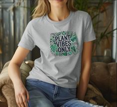 Embrace nature's energy with our "Plant Vibes Only" T-shirt, perfect for plant lovers and nature enthusiasts! This cozy and stylish tee features a vibrant botanical design, bringing the serene vibes of greenery into your everyday wardrobe. Made with soft, eco-friendly materials, this unisex T-shirt offers comfort and sustainability, making it the ideal choice for eco-conscious fashionistas. Whether you're lounging at home, running errands, or showing off your love for plants, this T-shirt is versatile enough to wear anywhere. It's a thoughtful gift for gardeners, plant parents, or anyone who appreciates the calming presence of nature. Available in multiple sizes, this T-shirt is perfect for men and women alike! - Made with medium fabric (5.3 oz/yd² (180 g/m consisting of 100% cotton for ye Eco-friendly Relaxed Fit Top With Graphic Print, Relaxed Fit Graphic Tee With Eco-friendly Ink, Eco-friendly Ink Tops With Relaxed Fit And Short Sleeves, Casual Crew Neck T-shirt With Eco-friendly Ink, Casual Everyday Tops With Plant Print, Casual Tops With Plant Print For Everyday, Plant Vibes, Botanical Aesthetic, Aesthetic Shirt