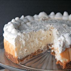 a cheesecake on a glass plate with one slice missing