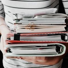 a person holding a stack of papers in their hands