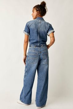 An updated classic... The Edison Wide Leg Coverall is a flattering denim jumpsuit you'll wear season after season. This workwear-inspired jumpsuit offers a comfortable, relaxed fit with a flattering cinched waistband, plus a wide leg silhouette and the perfect utility-style details. Features: Women's short sleeve denim coveralls Relaxed, wide-leg fit Cinched waistband detail Rigid, non-stretch denim Front button closure Collared neckline Adjustable drawstring waist Oversized workwear pockets We Fly Girls, Sporty Sneakers, Bedding Brands, Fashion 2024, Midi Maxi Dress, Sweater Set, Denim Jumpsuit, Ballet Flat, Long Blouse