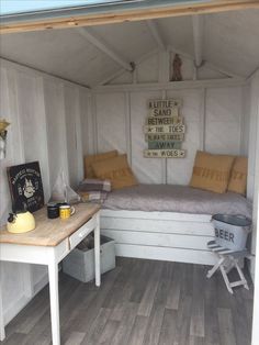 a bed sitting inside of a white room next to a wooden floor