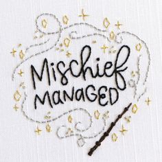 the embroidered sign is saying,'misshel managed'with an arrow in it