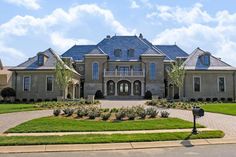 a large house with lots of windows and landscaping