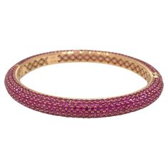 19.22 Carats Total Weight Ruby Pave Oval Bangle Bracelet in 18k Rose Gold Oval Shaped Pave Bangle Bracelet features 19.22 carats Round Rubies Pave set in 18k Rose Gold. Bangle has a hidden twist hinged opening. Total ruby weight is 19.22 carats. Bracelet fits a 6.5 inch wrist approximately and is 0.25 inches wide. Bracelet total weight is 28 grams. Set in 18k Rose Gold. Hallmarks: 18k, 750, 19.22 BUY WITH CONFIDENCE Authenticity is guaranteed for every item we sell. Pave Bangle, 18k Rose Gold, Ruby, Bangle Bracelets, Or Rose, Jewelry Bracelets, Bangles, Bracelet, Rose Gold