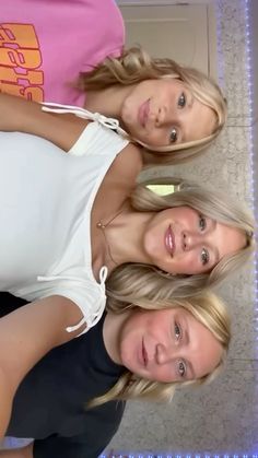 three young women are posing for the camera