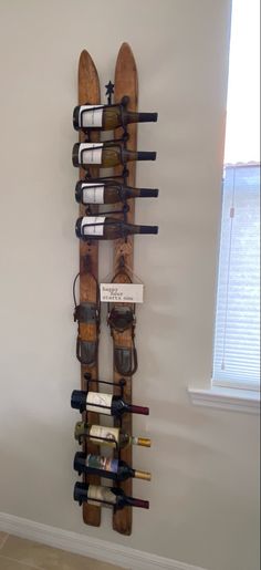 a wine rack made out of skis and other items in the corner of a room