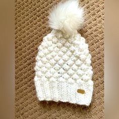 Never Worn Hat. Super Cut Knit Design With Faux Fur Pom. White One-size Bonnet For Cold Weather, White One Size Bonnet For Cold Weather, One Size White Bonnet For Cold Weather, Cozy Soft Knit White Bonnet, Winter White Yarn Bonnet, White Yarn Bonnet For Winter, White Hand Knitted Hat For Fall, White Knitted Yarn Beanie, White Crochet Hat For Winter, One Size