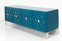 a blue cabinet with gold handles on it