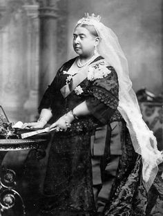 an old black and white photo of a woman in a wedding dress