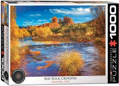 a puzzle box with a river and mountains in the background