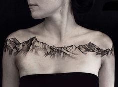 a woman with a mountain tattoo on her chest