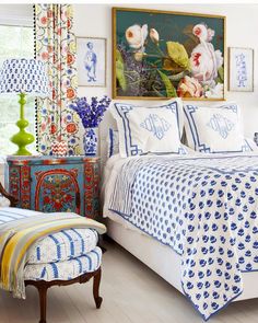 a bedroom with blue and white decor on the walls