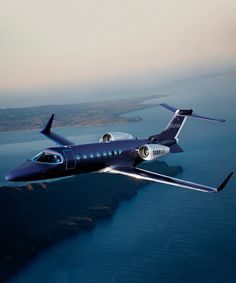 an airplane is flying over the water and land