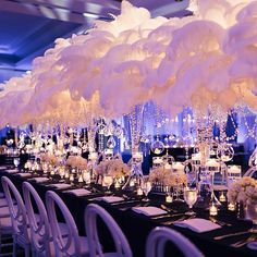 a long table with white flowers and candles