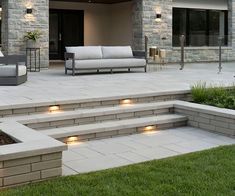 an outdoor living area with steps lit up