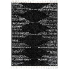 a black and white rug with fringes on the bottom, in an abstract pattern