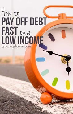 an orange alarm clock sitting on the side of a road with text overlay how to pay off debt fast or low income