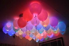 a bunch of balloons that are hanging from the ceiling