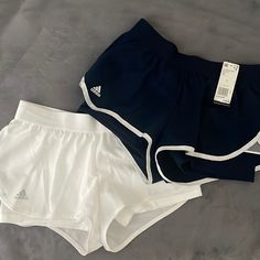 2 Pairs Of Shorts. Never Been Worn. Has A Spandex Layer Underneath. Mid Rise. Wind Breaker Material On Top. 1x White With Navy Detail. 1x Navy With White Detail. Adidas White Athletic Shorts With Built-in Shorts, Adidas White Athletic Shorts With Moisture-wicking, Adidas Stretch Moisture-wicking Shorts, Adidas White Gym Shorts, Adidas Stretch Shorts For Beach, Adidas Stretch Beach Shorts, Adidas Athletic Shorts For Gym, Summer, Adidas Stretch Bottoms For Workout, Adidas Stretch Athletic Shorts For Athleisure