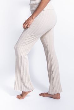 Layer up with our cozy three-piece loungewear made with thick ribbed knit. Features a V-neck sleeveless tank top, straight leg pants in a regular fit and matching long cardigan with button closure. Can be easily paired with a cup of tea or coffee and a good book. Product Material: 70% Viscose, 30% Polyester Beige Ribbed Bottoms For Loungewear, Spring Lounging Ribbed Pants, Ribbed Loungewear Bottoms For Spring, Trendy Ribbed Pants For Loungewear, Spring Ribbed Loungewear Bottoms, Ribbed Pants For Lounging, Spring Ribbed Beige Bottoms, Spring Beige Ribbed Bottoms, Chic Ribbed Loungewear Bottoms