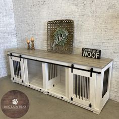 a white dog crate with two doors and a sign on top