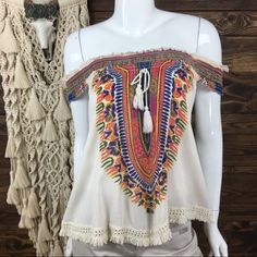 World Market Swing Tent Blouse. 2 Way Wear; Off Shoulder Or Scoop Neckline. Tassel Tie Front. Smocked Top Hemline. Fringe Trim Hem. Bohemian Design. Material: 100% Rayon (Lace): 100% Cotton Approximate Measurements Length Shoulder To Hem: 20 In. Pit To Pit: 18 In. Condition: Nwt. New With Tags. No Trades/Holdsalways Open To Reasonable Offers, Send Them Before Someone Else Does!!Bundle 2 Or More Items To Save More! Cream Bohemian Blouse For Vacation, Bohemian Cream Blouse For Vacation, Multicolor Sleeveless Smocked Top For Vacation, White Casual Top With Boho Collar, Casual Printed Peasant Top For Festivals, White Casual Tops With Boho Collar, Casual Festival Tops With Crochet Trim, Cotton Smocked Top With Short Sleeves For Vacation, Multicolor Embroidered Peasant Top For Beach