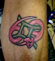 a tattoo on the leg of a man with pink and green ink that says love