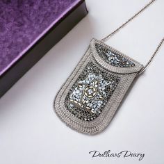 Introducing our Metal Mobile Shape Mini Handbag, a stylish fusion of elegance and functionality. Adorned with intricate mosaic work and gracefully curved around the bag, this accessory exudes a unique vintage charm. The beautiful silver chain adds a touch of sophistication, making it not just a handbag but a statement piece. Designed for modern living, this mini handbag is perfect for carrying essentials with style. Its compact size ensures convenience on the go, while the exquisite craftsmanshi Silver Rectangular Evening Bag, Elegant Square Phone Bag As Gift, Elegant Rectangular Portable Phone Bag, Elegant Portable Rectangular Phone Bag, Elegant Pouch With Cell Phone Pocket For Everyday Use, Elegant Shoulder Phone Bag As Gift, Elegant Travel Pouch With Cell Phone Pocket, Silver Rectangular Evening Bag For Travel, Elegant Clutch Phone Bag As Gift