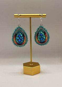 Large indigenous style beaded tear drop earrings.  These will only come in turquoise and red.  Dress them up or down, they will complete any outfit.  Super sparkly, lightweight and hypoallergenic.  These can be customized for clip-ons. Unique Beaded Teardrop Jewelry, Turquoise Teardrop Beaded Earrings As Gift, Turquoise Teardrop Beaded Earrings For Gifts, Unique Teardrop Jewelry With Colorful Beads, Unique Teardrop-shaped Jewelry With Colorful Beads, Beaded Teardrop Earrings As Gift, Beaded Teardrop Earrings For Gift, Turquoise Teardrop Jewelry For Crafting, Handmade Teardrop Earrings For Festival