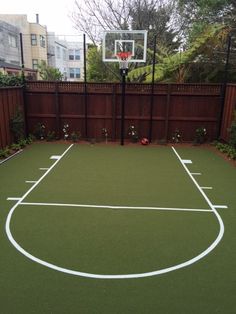 an outdoor basketball court in the backyard