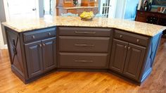 a kitchen with an island and granite counter tops