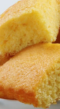 several pieces of cornbread in a white bowl with a fork and napkin on the side