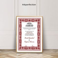 a red and white wedding certificate is displayed in front of a wooden frame on the floor