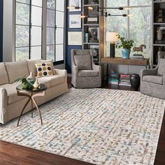 a living room with couches, chairs and a rug on the floor in front of windows