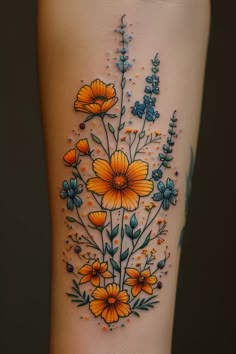 a tattoo with flowers and butterflies on the side of her leg, which is painted orange