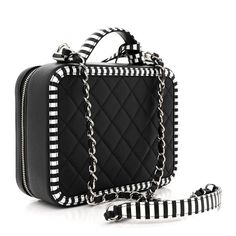 This is an authentic CHANEL Caviar Quilted Striped Medium CC Filigree Vanity Case in Black and White. This chic travel bag is crafted of luxurious diamond quilted caviar leather in black and white. This elegant shoulder bag features a silver chain-link shoulder strap threaded with leather, a white and black striped top handle, and a striped Chanel CC logo with silver accents on the front. The wrap-around zippers open to a partitioned red leather interior with zipper pockets. Chloe 2024, Vanity Case, Chanel Caviar, Diamond Quilt, Cc Logo, Silver Accents, Leather Interior, Black Stripes, Travel Bag