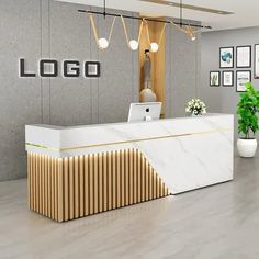 the front desk of a modern office with marble counter tops and gold trimmings