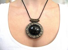 Gothic necklace, Black necklace gift, Victorian jewelry necklace, Black jewelry for women, Statement necklace, Statement jewelry gift Beautiful Black large Statement Victorian style necklace I made from polymer clay . I used bronze mineral pigments to made the frame of the necklace and the imitation of the black stone is with lines  in gold color. The necklace is with bronze filigree metal bail. Size : Pendant height  6 cm / 2.36'' Pendant width  6.2 cm / 2.44'' Necklace length  59 cm / 23.22'' Unique Black Resin Jewelry, Elegant Resin Pendant Necklace, Handmade Black Medallion Necklace, Elegant Handmade Polymer Clay Necklaces, Black Resin Round Pendant Necklace, Black Bohemian Polymer Clay Jewelry, Bohemian Black Jewelry Made Of Polymer Clay, Bohemian Black Polymer Clay Jewelry, Handmade Black Resin Necklaces