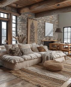 a living room filled with lots of furniture next to a stone wall covered in windows