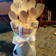 a stack of wooden spoons wrapped in white ribbon