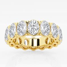 a yellow gold ring with five diamonds on the front and center, set against a white background