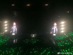 two men standing in front of green lights