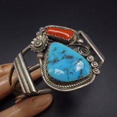 "VINTAGE NAVAJO BRACELET DESCRIPTION: This classic cuff features Sleeping Beauty turquoise along with old red Mediterranean coral. The gemstones are secure in scalloped bezel, on a foundation of heavy gauge vintage sterling silver. This bracelet will be a cherished addition to your collection of fine vintage Native American jewelry. MEASUREMENTS: Interior of the cuff measures 5 1/2\" with an additional 1\" slightly adjustable gap. Total circumference: 6 1/2\" Measures 2 3/8\" straight across the Vintage Red Adjustable Bracelet, Vintage Red Adjustable Bracelets, Vintage Adjustable Red Bracelets, Vintage Handmade Red Bangle, Red Retro Bangle Jewelry, Vintage Red Adjustable Cuff Bracelet, Red Vintage Adjustable Cuff Bracelet, Red Adjustable Vintage Cuff Bracelet, Vintage Red Adjustable Bangle