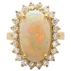 an opalite and diamond ring in yellow gold with white diamonds on the sides