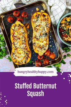 stuffed butternut squash on a baking sheet with cherry tomatoes and parmesan cheese