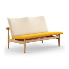 a white and yellow couch sitting on top of a wooden frame