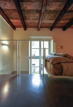 an empty room with a bed and sliding glass doors leading to the outside patio area