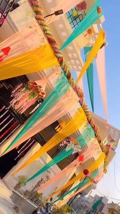 colorful streamers hanging from the side of a building